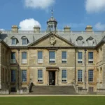 What is the history and origin of Woolton Hall in Liverpool