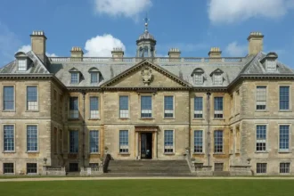 What is the history and origin of Woolton Hall in Liverpool